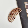 Curved acetate hair comb featuring amber and beige tortoiseshell patterns on a sleek finish - Turquoise Oval