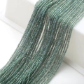 Macro shot of 2mm dark green faceted glass beads on strings for DIY jewelry making - Transparent Green
