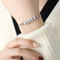 Silver snake chain bracelet with sparkling crystal cylinders on a female model - Crystal Cylinder Style (E408) / Silver Tone (E408)
