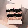 Detail view of 4-piece satin hair scrunchies set in black and champagne on card - Black and Ivory