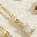 Close-up of rectangular emerald-cut zircon pendant on 14K gold-plated choker chain - White