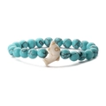 Close-up of turquoise beaded elastic bracelet featuring a white dolphin ceramic charm - Green Veined Turquoise