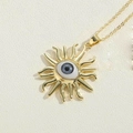 Macro shot of gold sun evil eye pendant necklace showing fine metallic textures - Sun Design 2
