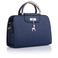 Navy blue faux leather handbag with V-quilt pattern and deer charm in a 45-degree view - Blue