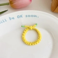 Elastic yellow knit hair tie for girls with green plastic tips on a ceramic plate - Yellow