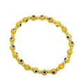 Detail of yellow evil eye beaded bracelet with gold spacers on white background - Yellow
