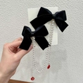 Close-up of velvet bow hair clips with long pearl chains and red Fu character pendants - Black Velvet Bow Hair Clip with Artificial Pearl Tassels