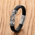 Men's black braided leather bracelet with silver anchor knot and magnetic clasp on wood - Knot