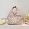 Pink floral canvas lunch bag with wide handles and stylish brand label detail - Colorful