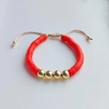 Detail of red heishi bead bracelet with gold metal accents and adjustable drawstring cord - Red Clay with Four Gold Beads Adjustable Cord