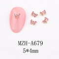 Macro view of 5x4mm bow-shaped nail charms with gold base and pink rhinestones - A679