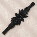 Macro detail of hand-sewn black crystal beads and rhinestones on elastic headband - Black