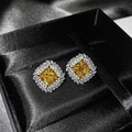 Detailed macro view of luxury square yellow diamond stud earrings in a black velvet jewelry box - Yellow Zirconia Stud Earrings (Pair)