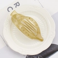 Translucent yellow oval claw clip in a cutout design on a decorative ceramic plate - 11.5cm / Jelly Green