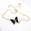 Detail of adjustable gold chain bracelet with a black butterfly pendant and zircons - Black