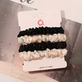 Detailed set of four satin hair scrunchies in black and cream on display card - Black and Off-White