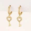 Close-up of gold hoop earrings with sparkling zircon heart key pendants on white card - K-Heart Key