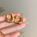 Vintage gold U-shaped enamel earrings with French luxury metallic finish - Golden Twisted Trapezoid Hoop (HE11467)