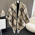 Detail of soft beige and black plaid knit shawl wrap on mannequin in indoor setting - Khaki Beige Plaid