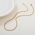 Flat lay of an 18k gold plated Cuban link chain necklace with lobster clasp on white - 04 Curb Chain