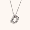 Macro shot of silver 18K stainless steel 3D puffy initial D pendant and chain necklace - Steel-D