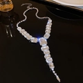 Macro detail of geometric crystal pendant necklace with emerald-cut zirconia on dark mirror - Silver Rhinestone Square Style