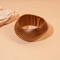 Macro shot of wide wooden bangle showing detailed orange and black grain texture - Deep Coffee Patterned