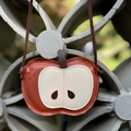 Macro shot of apple-shaped crossbody bag featuring lychee texture and fine stitching details - Apple Red