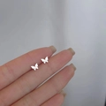 Elegant silver butterfly stud earrings with a minimalist metal finish and pearl accents - Folded Butterfly / Silver