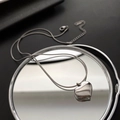 Macro detail of silver heart pendant and sleek snake chain on a reflective mirror - 03-E10 Titanium Steel Heart Necklace Silver