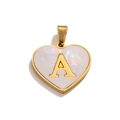 Macro shot of a golden heart pendant with a white pearlescent inlay and golden letter A - Letter A / Gold