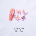 Macro shot of 10x12mm Aurora crystal butterfly nail charms with metallic bead accents - MJ03 Pink Purple Mocha