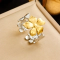 Detailed macro view of two-tone gold and silver flower petal ring on jewelry box - Floral Embossed Design (R572)
