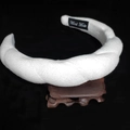 Detail of soft white plush headband showing thick twisted velvet texture and handmade label - Twisted Sponge Headband / White