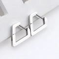 Polished silver triangle huggie earrings in stainless steel on white stone display - Diamond-Shape 14mm Steel Color