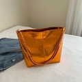 Metallic orange tote bag featuring a gold chain strap and spacious bucket design - Orange