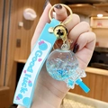 Luminous lollipop keychain with blue glitter stars, silicone strap, and gold bell charm - Noctilucent Bubble Bead Lollipop-Blue