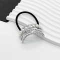 Detailed shot of silver twisted metal hair tie with inlaid white pearls on black band - Large / Silver