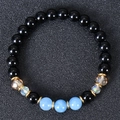 Macro view of multi-color natural stone beads bracelet with gold gear spacers on dark background - Black Polished Beads with Light Blue and Gold Spacers (Style-5)