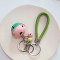 Pink and green bell keychain with woven strap and silver metal clasp hanging detail - Pink & Green