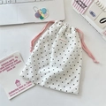 Detailed view of white polka dot drawstring pouch with a red SOZAKKA brand logo label - Large / Light Pink Rope