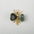 Golden butterfly wing brooch featuring heart-shaped green crystal stone inlays - Moss Agate