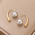 Macro detail of two-tone gold teardrop and silver ball earrings on jewelry box liner - Two-tone Ball Pendant Hook Style (N-814) / 54 KC Gold+White K
