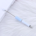 DIY beadable ballpoint pen in light blue and white finish on a soft textured background - Azure White