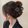 Large black hair claw clip with golden heart detail shown on model's hairstyle - Elegant Heart Decor Black