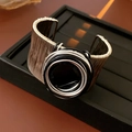Detail of handcrafted multi-layer silver wire wrap bracelet with black onyx center - Black Stone Center Inlay / Silver Black