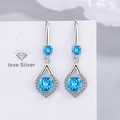 Elegant silver earrings featuring dual round blue moissanite stones and diamond halo - Blue Diamond Earrings Led-108