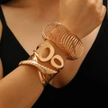 Set of 3 gold-toned bracelets featuring open cuff and spiral textured metal designs - Bangle Set (53) / Three-Piece Set / KC Gold