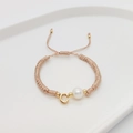 Detail of hand-woven cord bracelet with a pearl and golden letter C pendant charm - Letter C