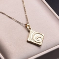 Close-up of 18k gold plated square swirl pendant on a soft beige jewelry box cushion - Gold (Pendant Necklace)
